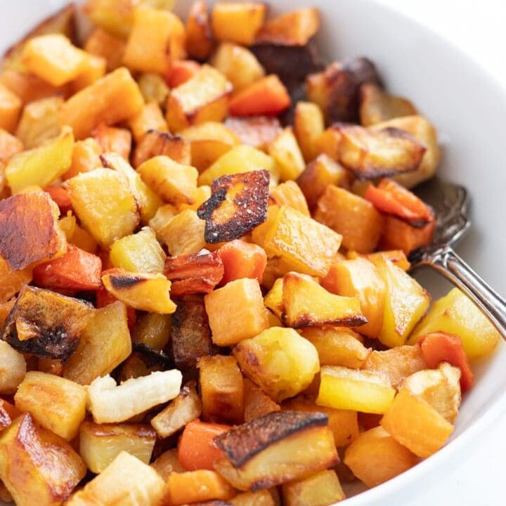 A white bowl filled with low FODMAP roasted root veggies