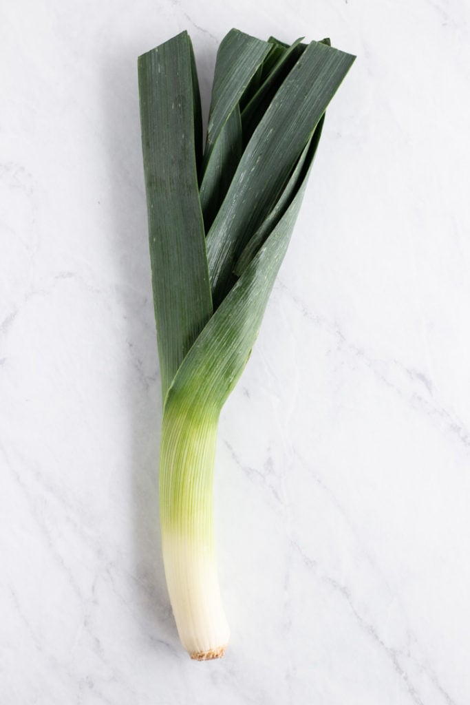 A leek on a white marble background